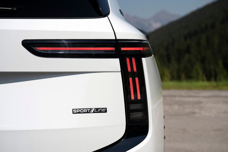 Close-up of the rear tail light and Sport Line badge on a white Skoda Enyaq SUV