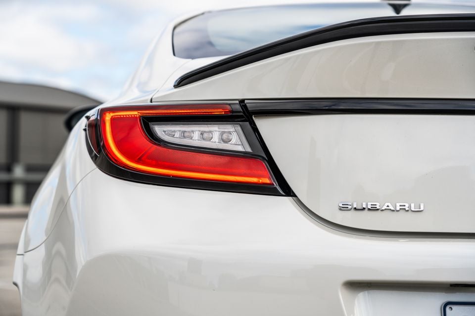 Close-up of the rear tail light and Subaru badge on a white Subaru BRZ tS