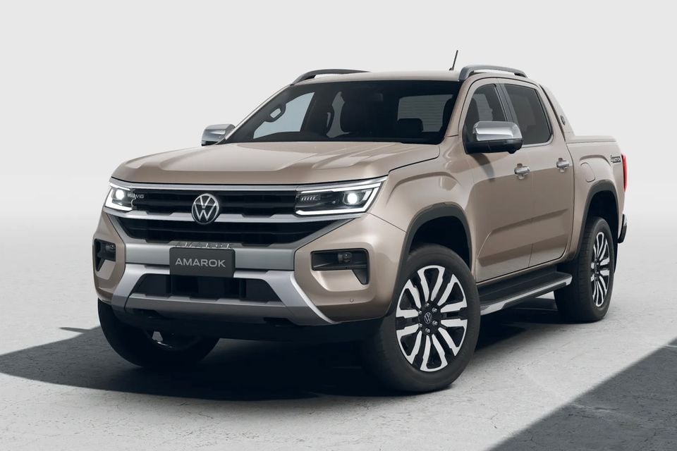 Volkswagen Amarok dual-cab ute in a light beige colour, seen from the front three-quarter angle on a studio background