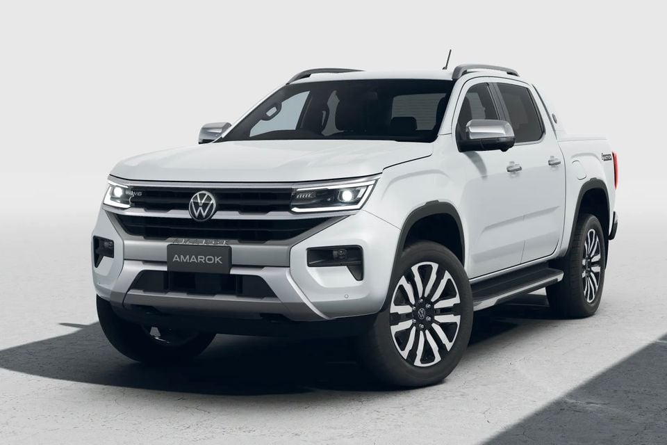 A white Volkswagen Amarok dual-cab ute seen from the front quarter angle against a light studio background