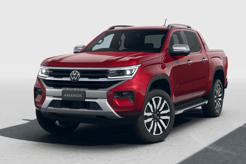 A red Volkswagen Amarok dual-cab ute seen from the front three-quarter angle against a light studio background