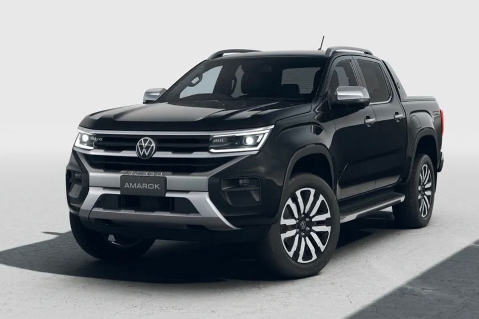 A black Volkswagen Amarok dual-cab ute seen from the front-side against a light studio background