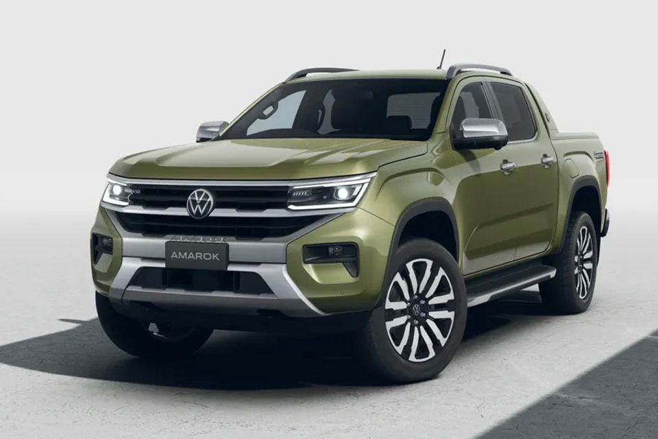 A green Volkswagen Amarok dual-cab ute seen from the front three-quarter angle against a light studio background