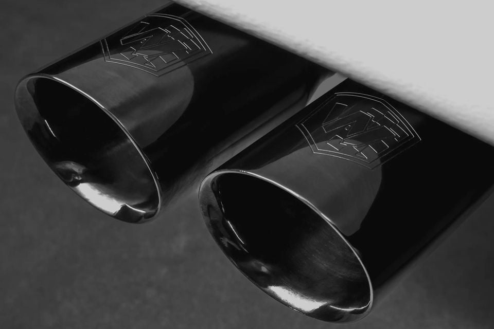 Close-up of twin exhaust tips with an embossed badge logo on a Volkswagen Amarok W600 by Walkinshaw