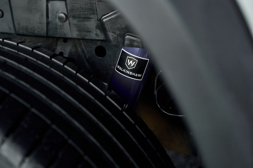 Close-up of a Walkinshaw-branded shock absorber or suspension component visible through the wheel arch of a Volkswagen Amarok W600