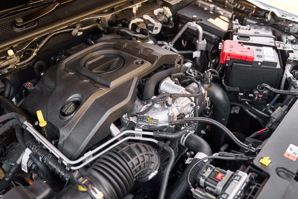 Engine bay of a Volkswagen Amarok W600 by Walkinshaw, showing the turbocharged engine, battery, and surrounding components with the bonnet open.