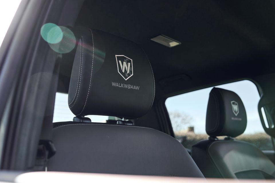 Walkinshaw-branded black leather headrests inside a Volkswagen Amarok, showing the Walkinshaw logo and name embroidered on the front and rear seats.