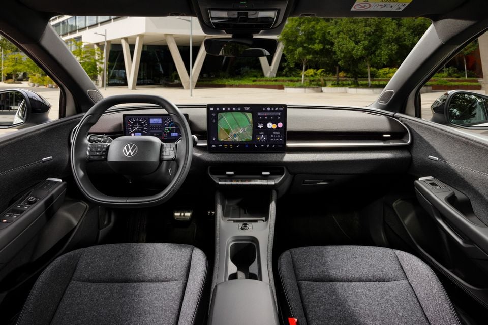 Interior of a Volkswagen ID. Polo showing the dashboard, steering wheel, central touchscreen infotainment display, and front seats
