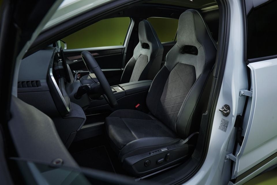Front seats of the 2027 Volkswagen ID. Tiguan with grey suede sports bucket seats, viewed through the open driver's door.
