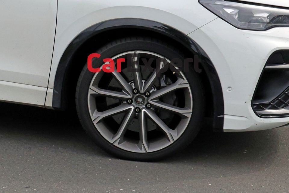 Close-up of a large multi-spoke alloy wheel on a white Volkswagen Tiguan R, showing a large brake calliper behind the rim
