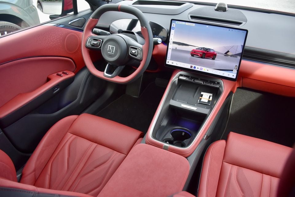 Interior of a Zeekr 7GT showing red leather seats, steering wheel, centre console, and a large touchscreen infotainment display