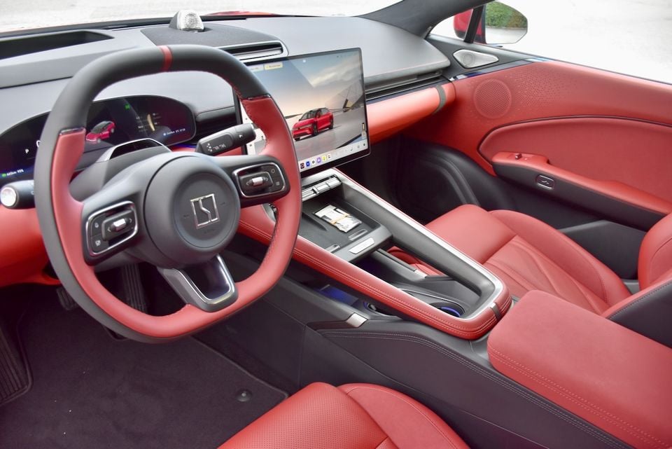 Interior of a Zeekr 7GT showing the red leather seats, steering wheel, centre console, and large touchscreen infotainment display