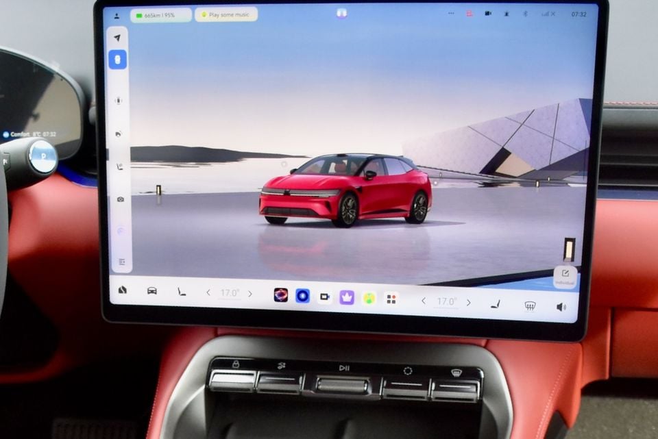 The central touchscreen infotainment display of a Zeekr 7GT showing a red SUV on its home screen, with red leather interior visible in the foreground