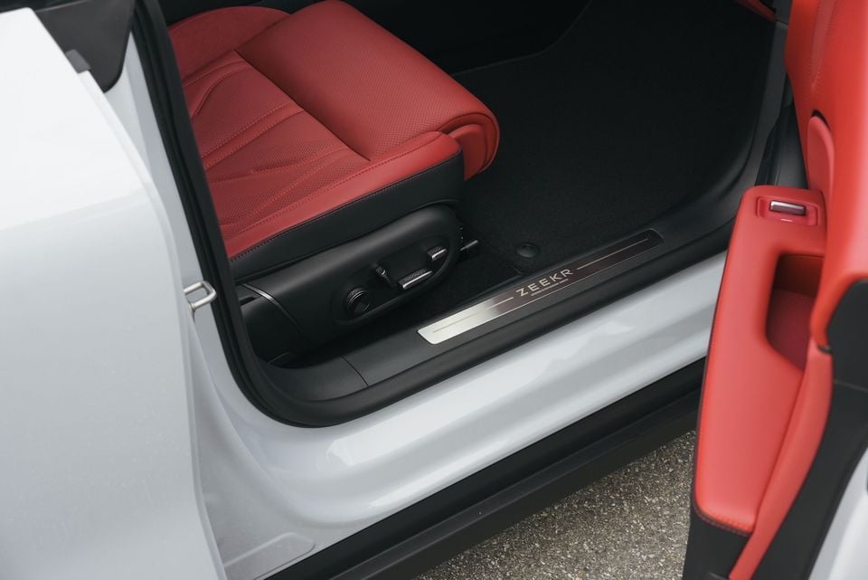 Zeekr door sill plate with the Zeekr logo, alongside red leather front seat interior