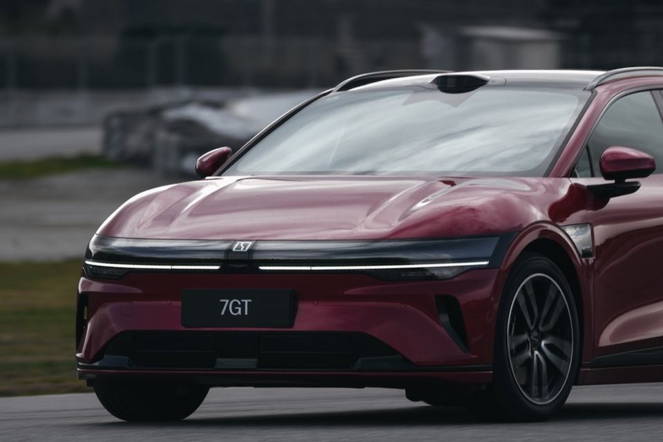 A dark red Zeekr 7GT seen from the front quarter angle on a track
