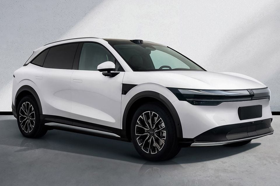 A white Honda electric SUV seen from the front-side angle in a studio setting