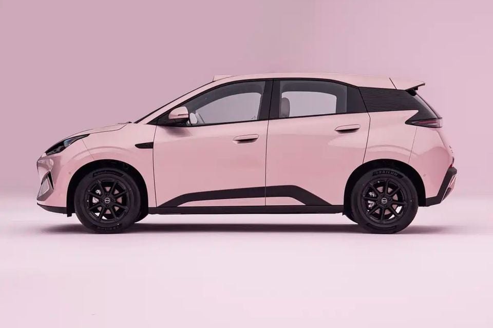 A pink 2027 BYD Atto 1 hatchback shown from the side against a pink studio background.