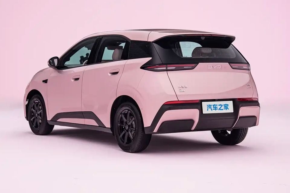 A pink 2027 BYD Atto 1 hatchback shown from the rear quarter in a studio setting