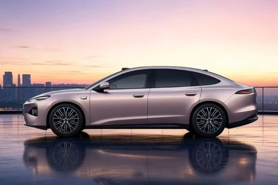 A pink 2027 BYD Seal sedan photographed from the side on a rooftop at sunset with a city skyline in the background.