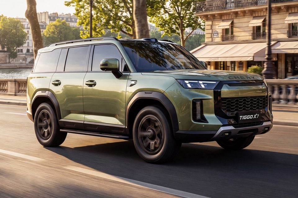A green 2027 Chery Tiggo X7 SUV driving along a riverside city street, seen from the front three-quarter angle
