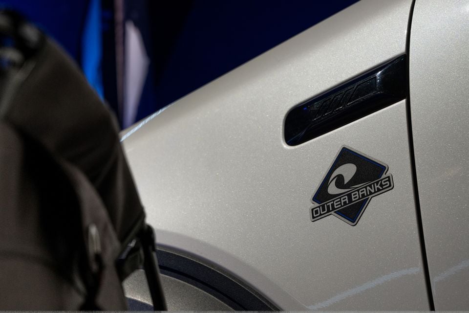 Close-up of the Outer Banks badge on the front fender of a silver Ford Bronco