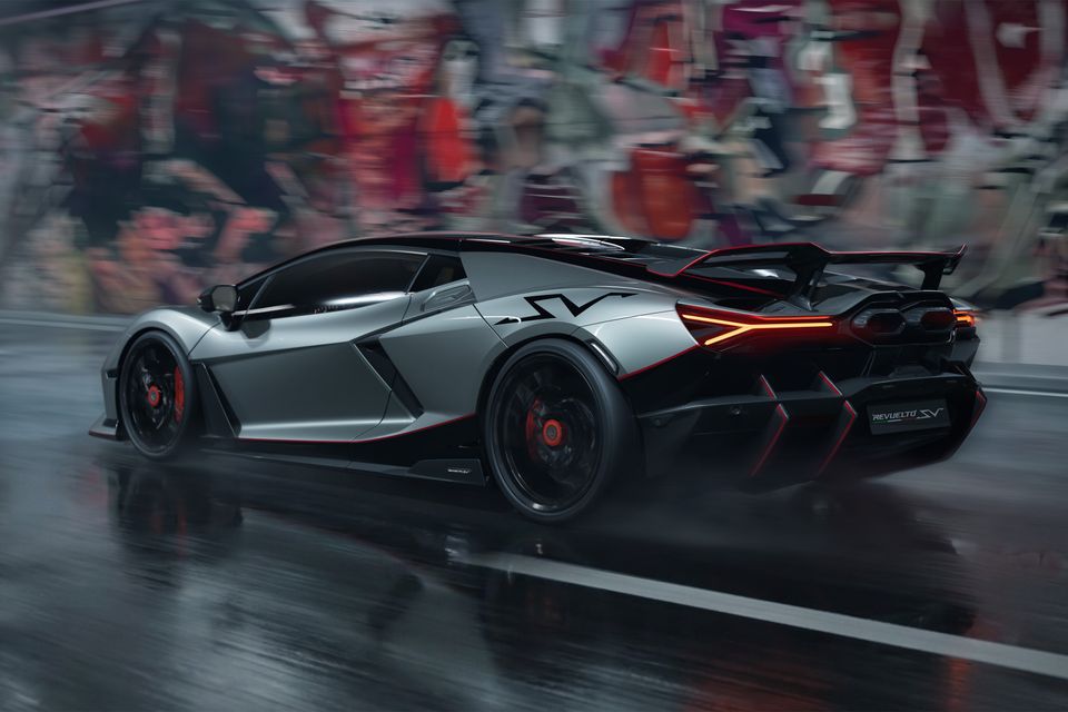 A Lamborghini Revuelto SV supercar seen from the rear three-quarter angle, driving on a wet track with motion blur in the background