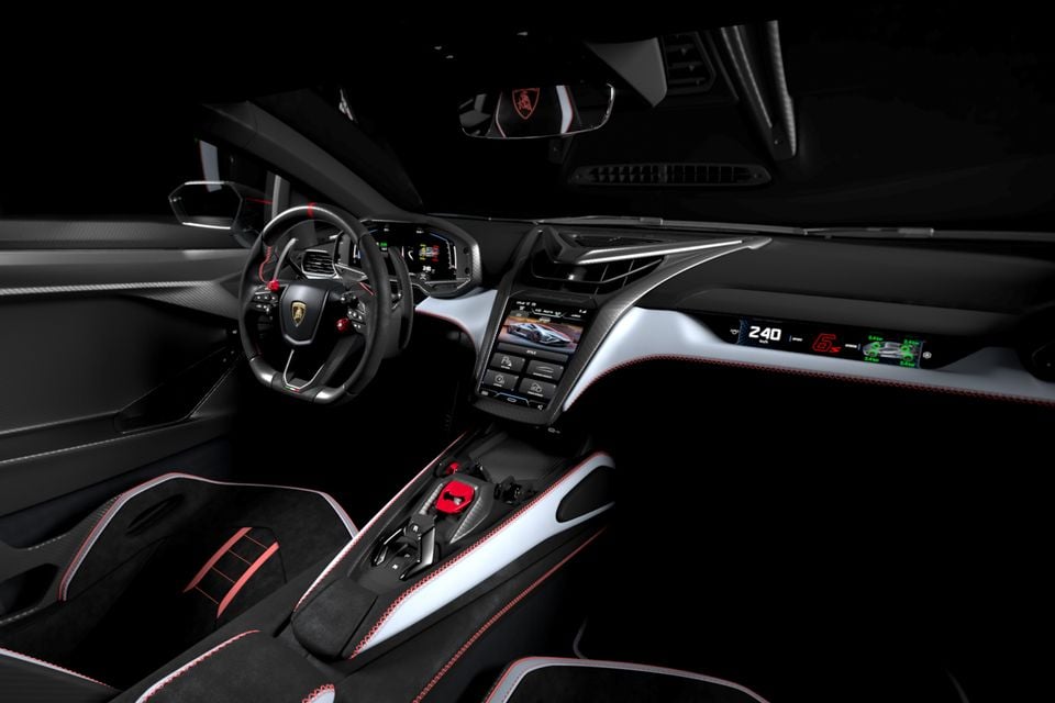 Lamborghini Revuelto SV interior showing the dashboard, carbon fibre steering wheel with Lamborghini badge, central touchscreen infotainment system, and black seats with red stitching accents
