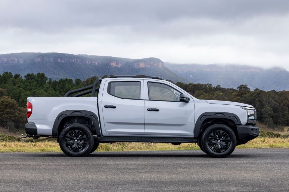 A white 2027 LDV T60 dual-cab ute parked on a road, seen from the side with mountains in the background.