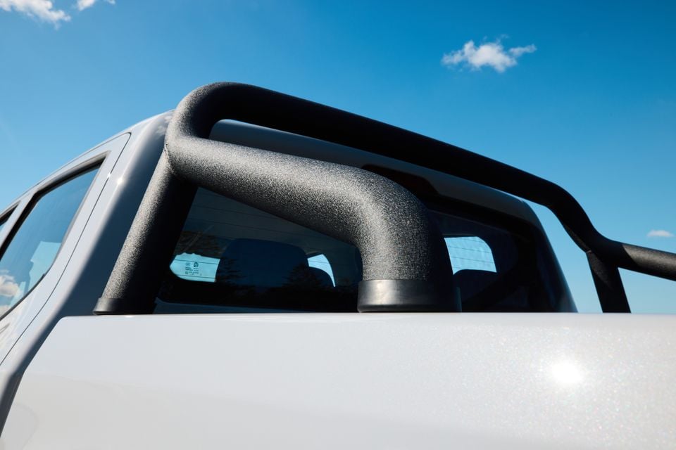 Close-up of the black sports bar mounted over the tray of a white LDV T60 ute against a blue sky