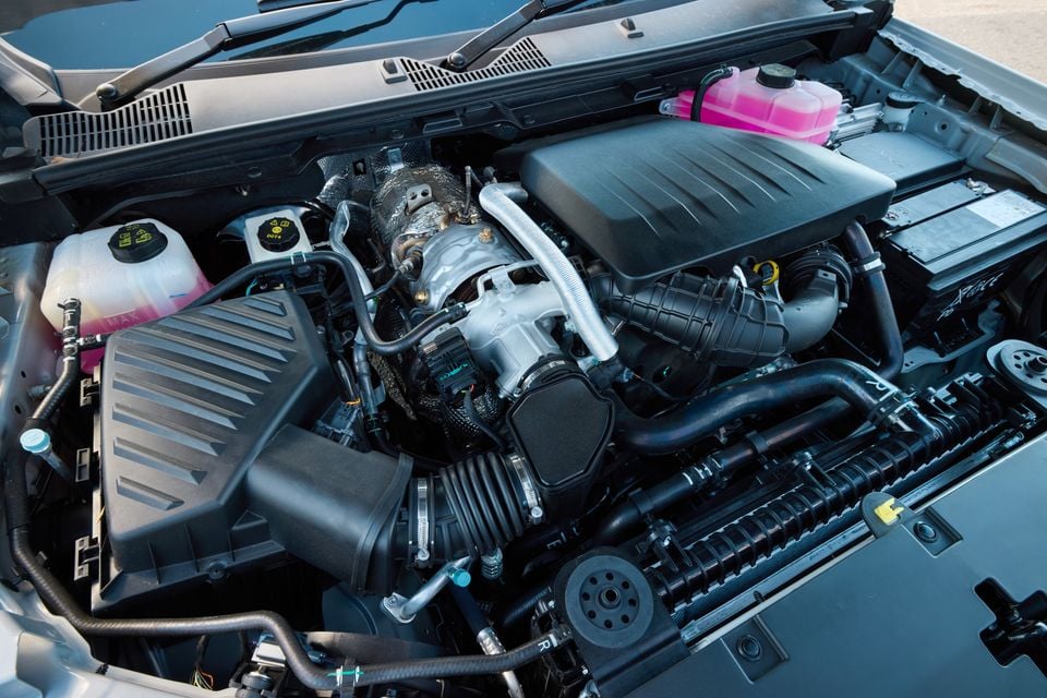 Close-up view of the engine bay of a 2027 LDV T60 Luxe with the hood open, showing the engine, fluid reservoirs and battery