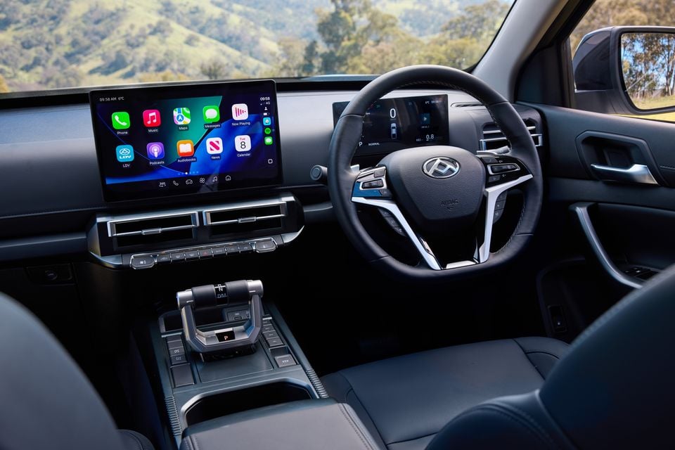The interior of a 2027 LDV T60 Luxe ute, showing the steering wheel, touchscreen infotainment display and centre console gear selector.