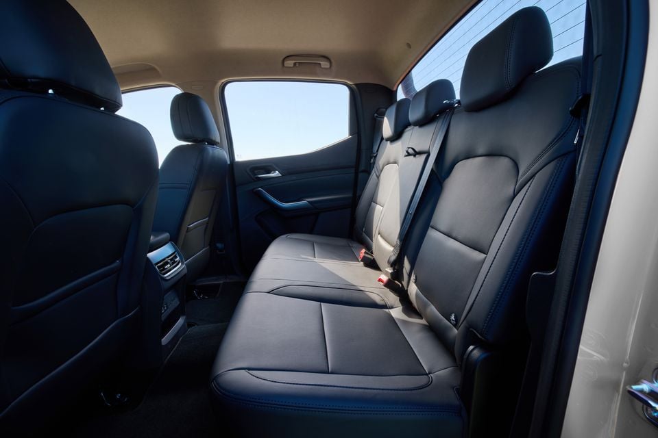 The rear seats of a 2027 LDV T60 Luxe dual-cab ute, showing black leather upholstery and seatbelts