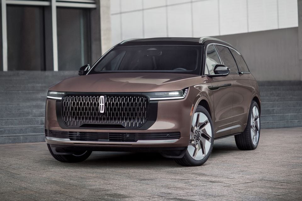 A brown 2027 Lincoln Nautilus Black Label SUV seen from the front three-quarter angle, parked in an urban setting