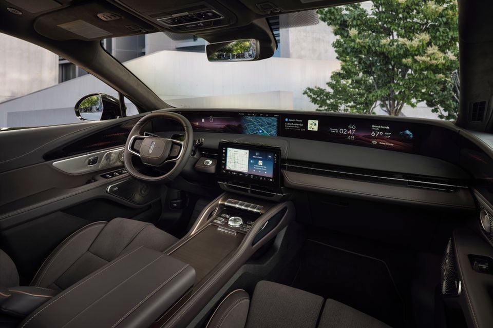 Interior of a 2027 Lincoln Nautilus Black Label showing the panoramic widescreen display, steering wheel, centre console and infotainment touchscreen