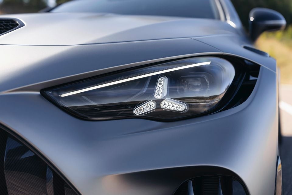 Close-up of the LED headlight on a silver Mercedes-AMG CLE, showing a three-pointed star DRL signature within the light cluster