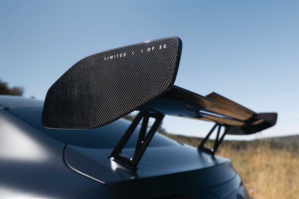Close-up of a carbon fibre rear wing on a Mercedes-AMG CLE limited edition vehicle, inscribed with 'LIMITED | 1 OF 30'