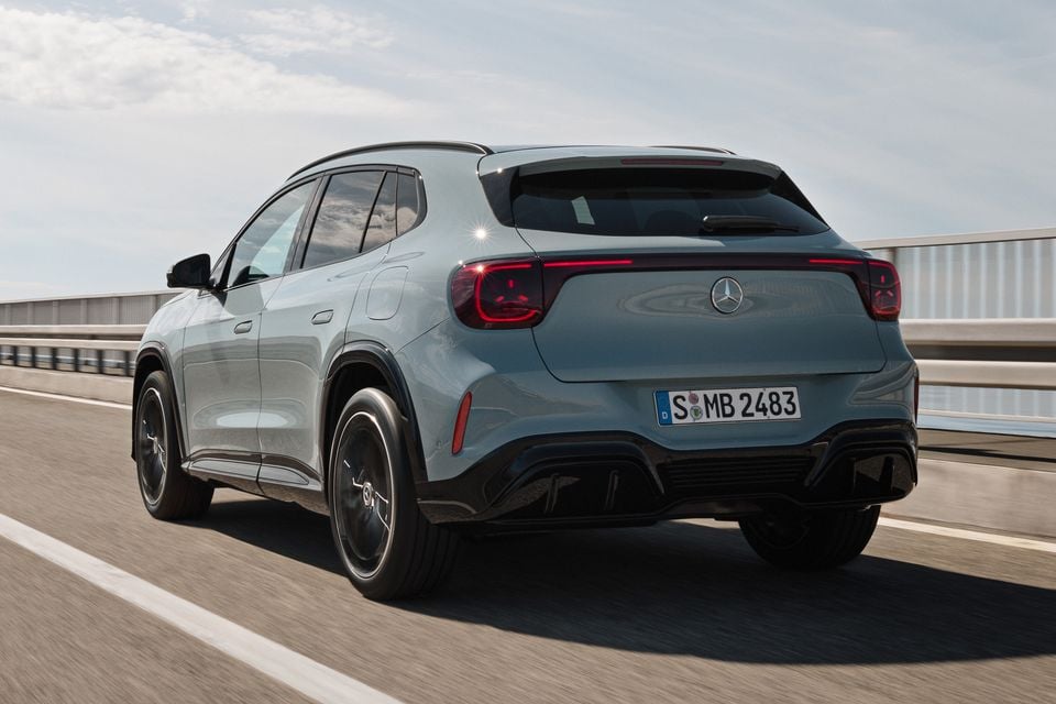 A light blue 2027 Mercedes-Benz GLA SUV seen from the rear while driving on a highway