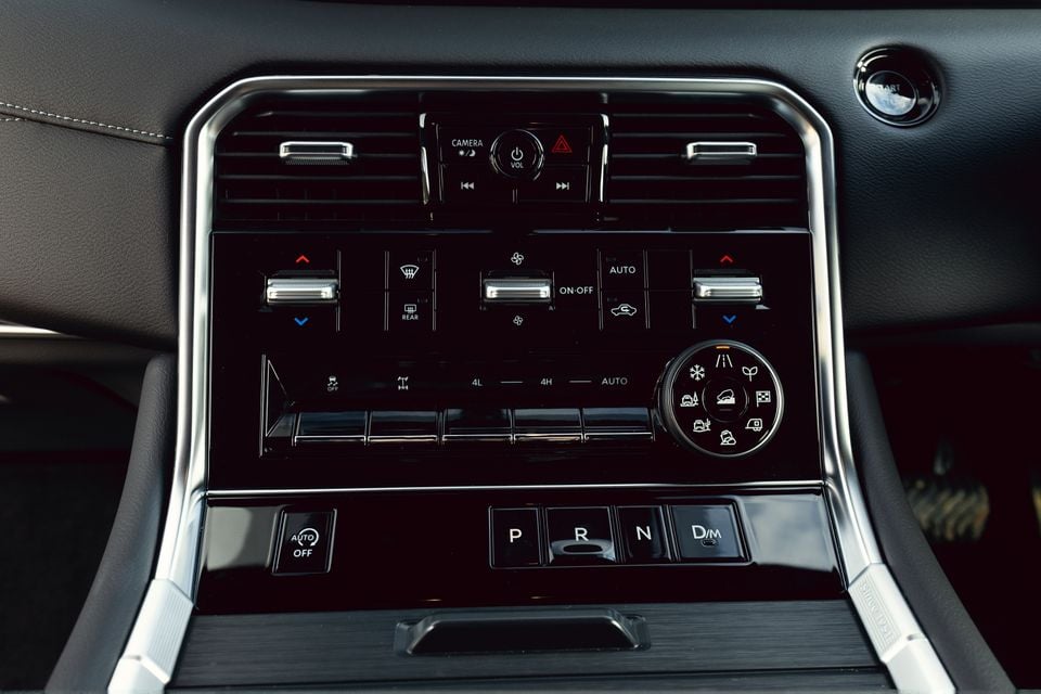 Interior centre console of the 2027 Nissan Patrol Y63 showing climate controls, drive mode selector, 4WD transfer switch, and gear selector buttons