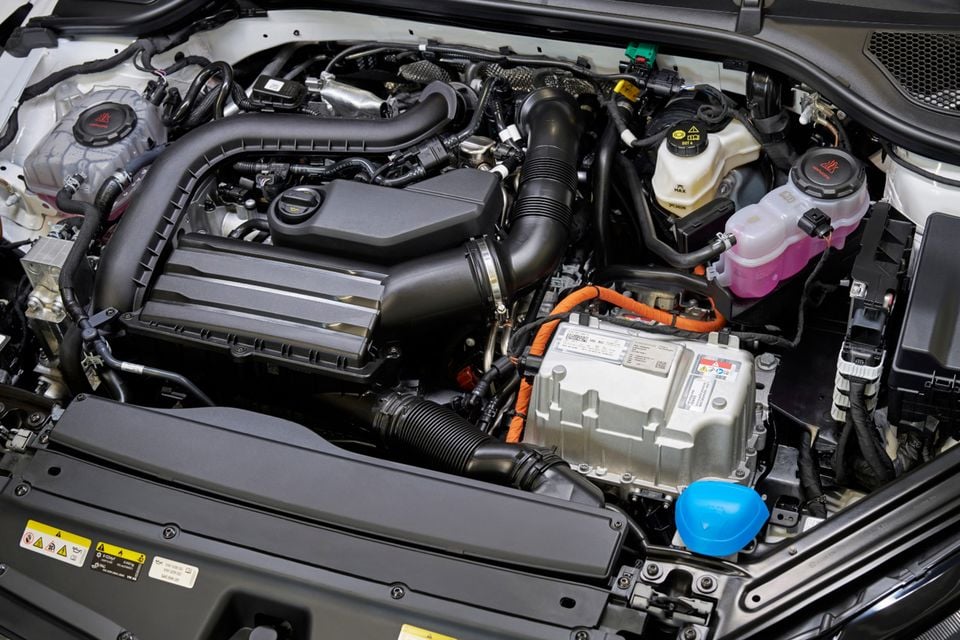 Close-up view of the hybrid engine bay of a 2027 Skoda Octavia wagon, showing the engine cover and hybrid electric components