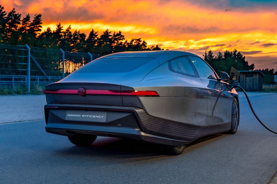 Rear view of the Volkswagen Mission Efficiency concept car plugged in to charge, photographed at sunset
