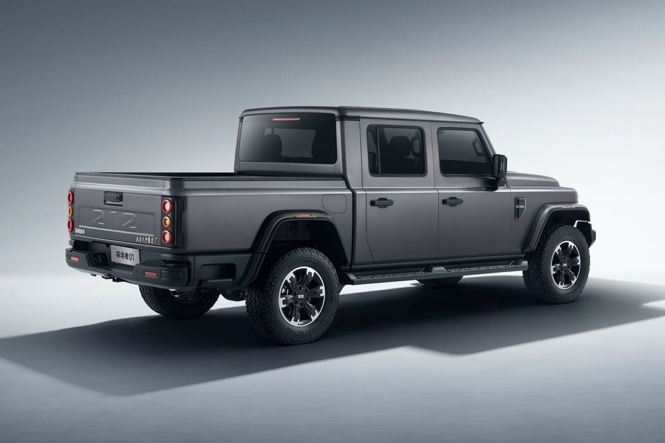 A dark grey 212 T01 Explorer 01 dual-cab ute seen from the rear three-quarter angle in a studio setting