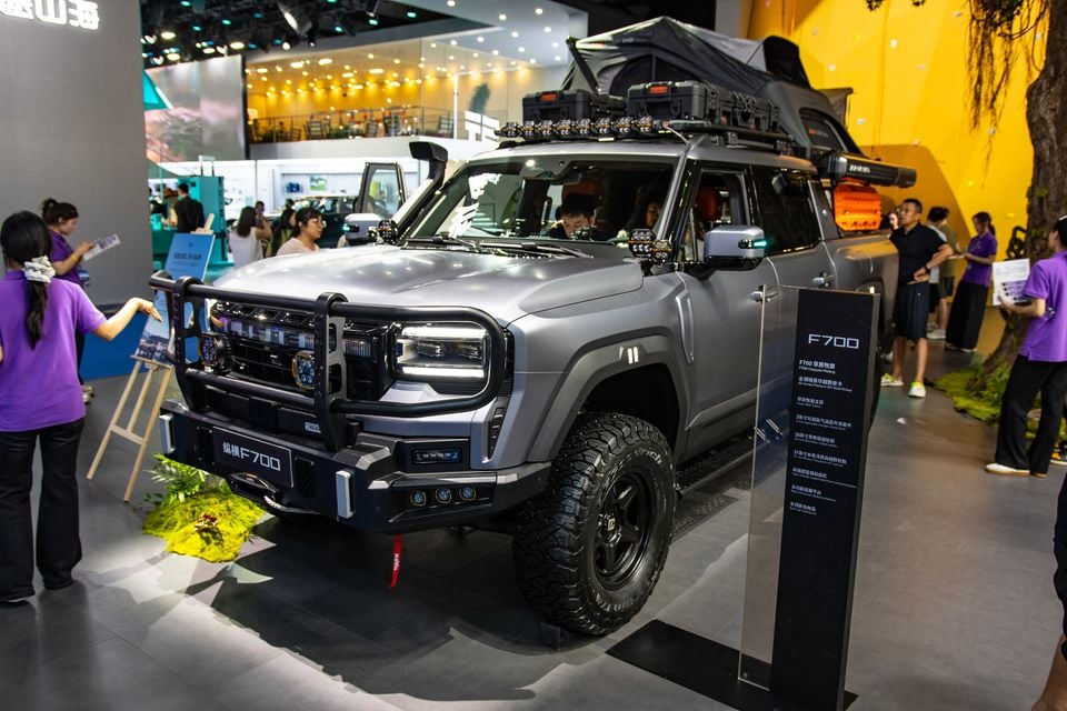 A grey Jetour F700 SUV with off-road accessories including a roof tent, bull bar, and all-terrain tyres on display at the Chengdu Motor Show