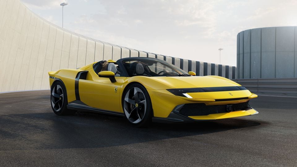 A yellow Ferrari 12Cilindri Spider supercar seen from the front three-quarter angle, parked on a track surface