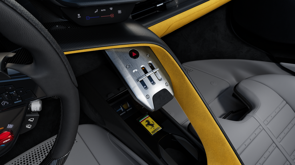Ferrari interior centre console with gear selector, yellow Alcantara trim, carbon fibre accents, and the Ferrari prancing horse badge