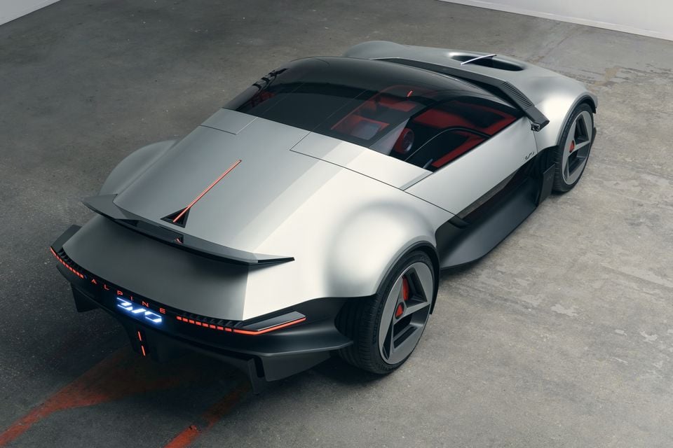 Silver Alpine A310 Vision concept sports car seen from above and behind, showing its glass canopy, rear wing and illuminated rear light bar
