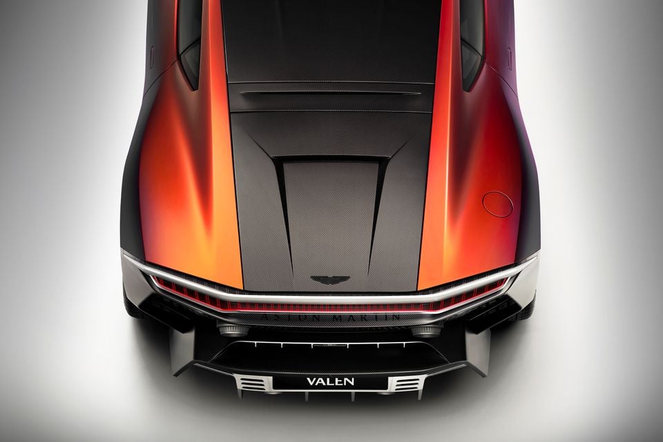Aston Martin Valen supercar seen from above, showing the carbon fibre bonnet and orange bodywork with front splitter detail