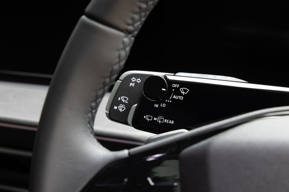 Close-up of the wiper control stalk on an Audi Q3, showing wiper speed settings including OFF, AUTO, LO, HI, and rear wiper controls