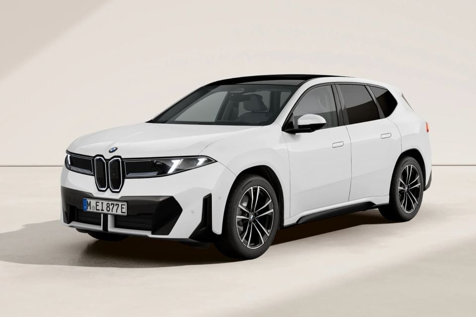 A white BMW iX3 electric SUV shown from the front three-quarter angle against a neutral studio background.