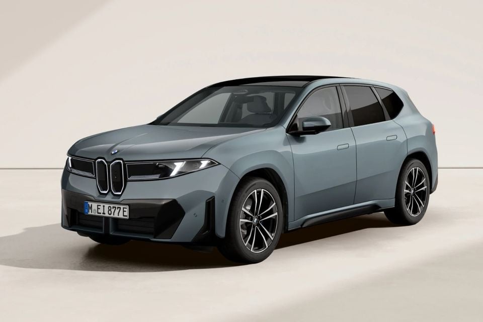 A grey BMW iX3 SUV shown from the front three-quarter angle against a neutral studio background.