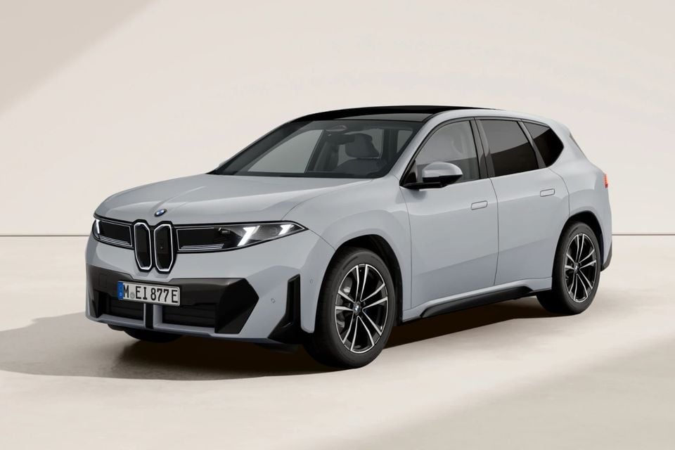 A grey BMW iX3 electric SUV shown from the front-side angle against a neutral studio background